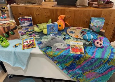 selection of soft toys representing sea creatures with books for childcare
